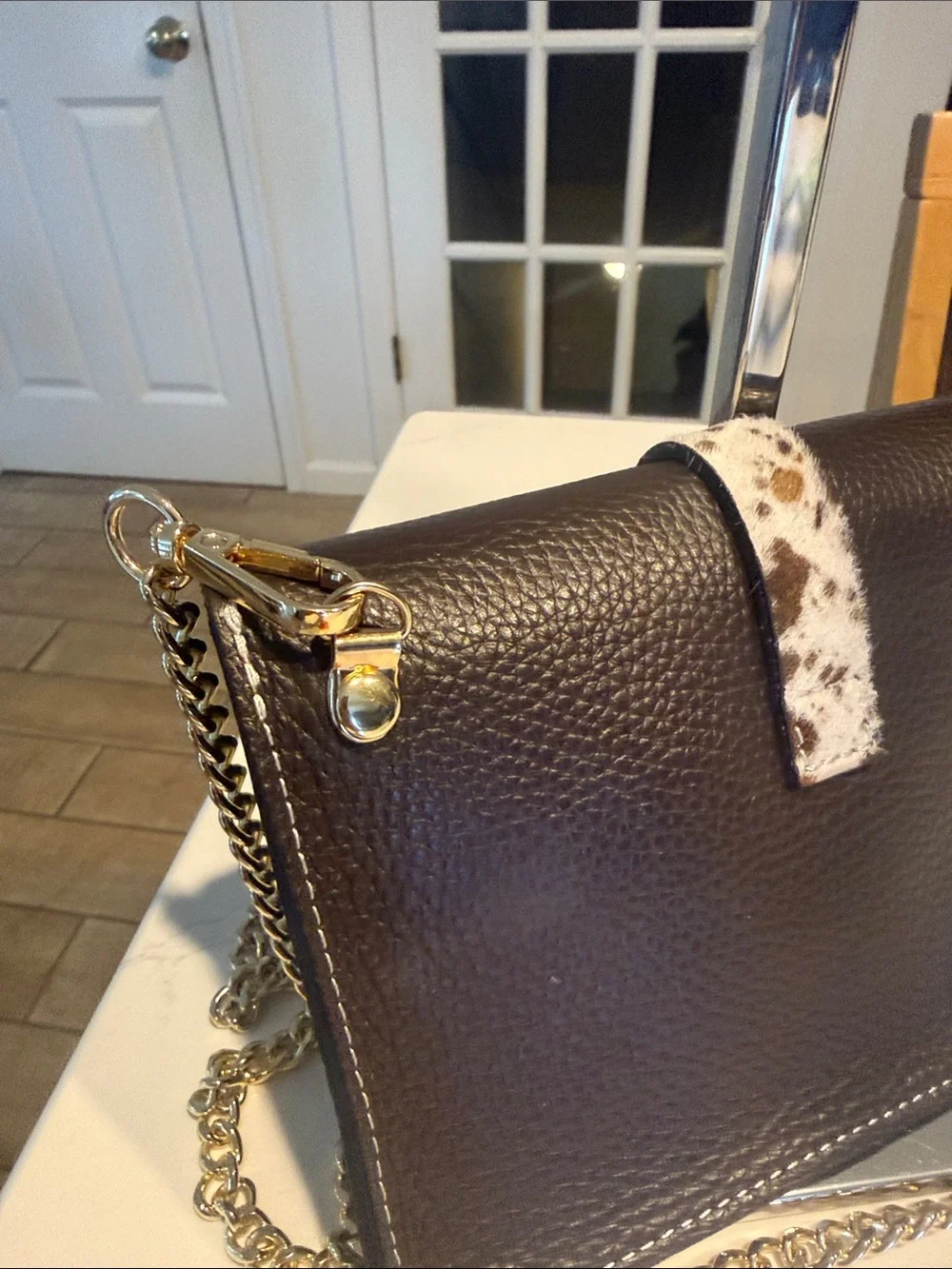 Black Pebbled Leather Crossbody Bag with Speckled Tab and Gold Chain